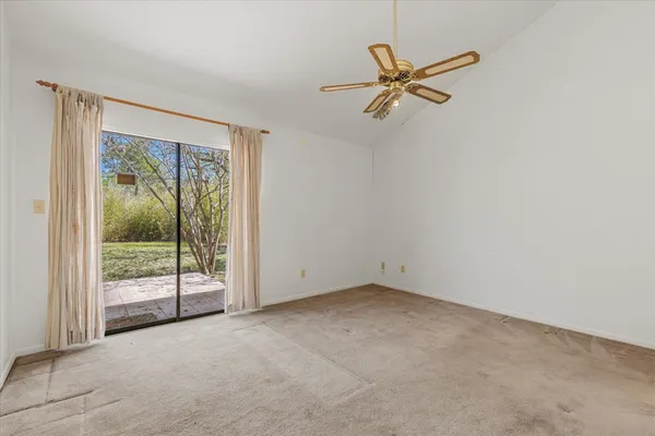 a view of a livingroom with a ceiling fan and hardwood floor