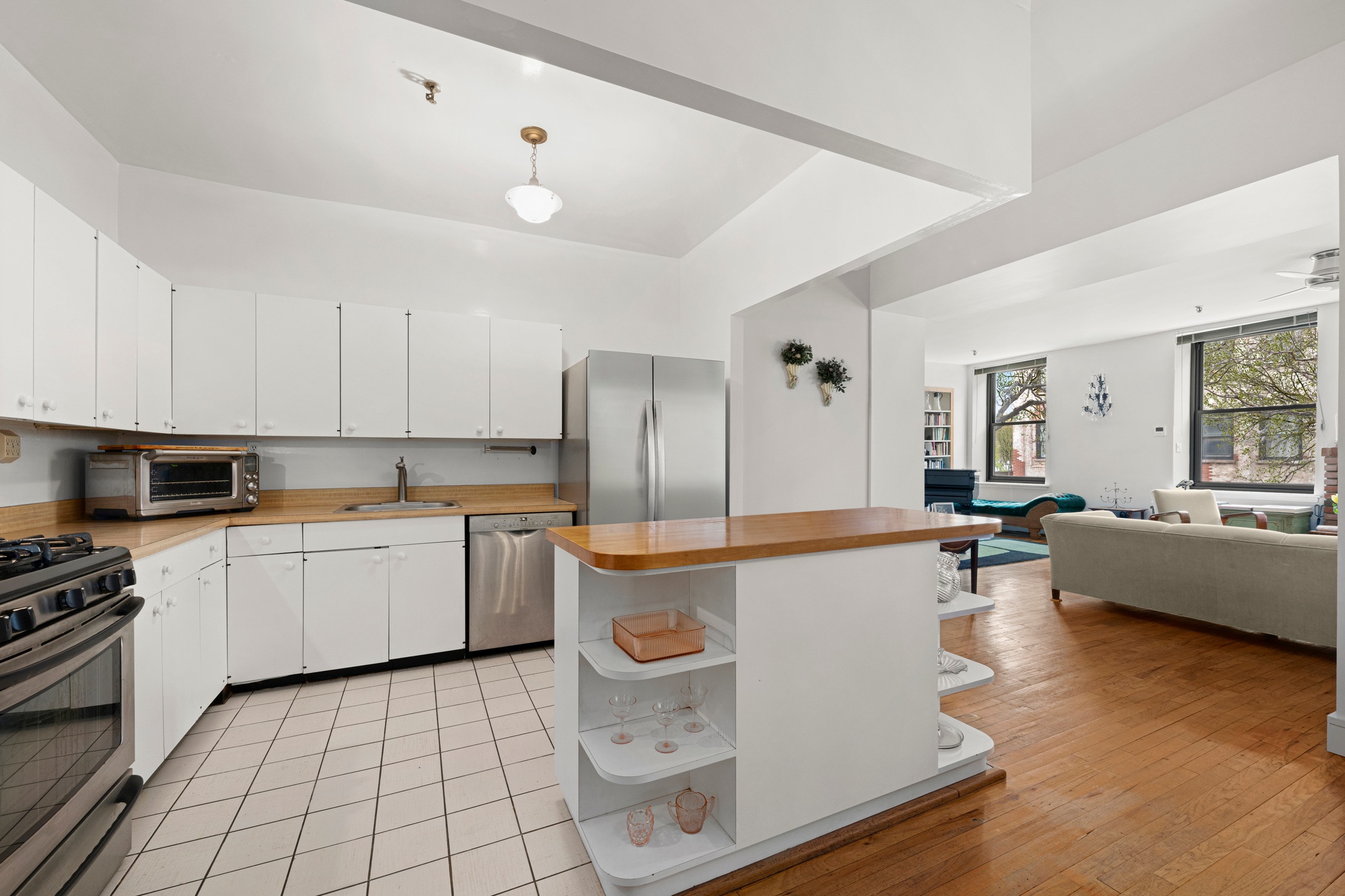 166 Bank Street, Unit LOFT2C Manhattan, NY 10014 - Photo 4 of 11 a kitchen with a sink a counter top space and stainless steel appliances