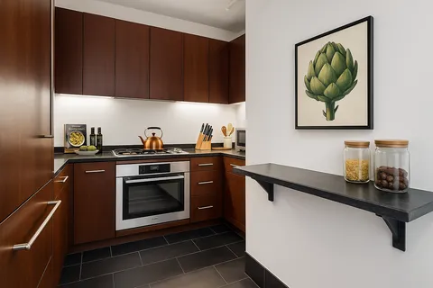 a kitchen with stainless steel appliances a stove a sink and a microwave