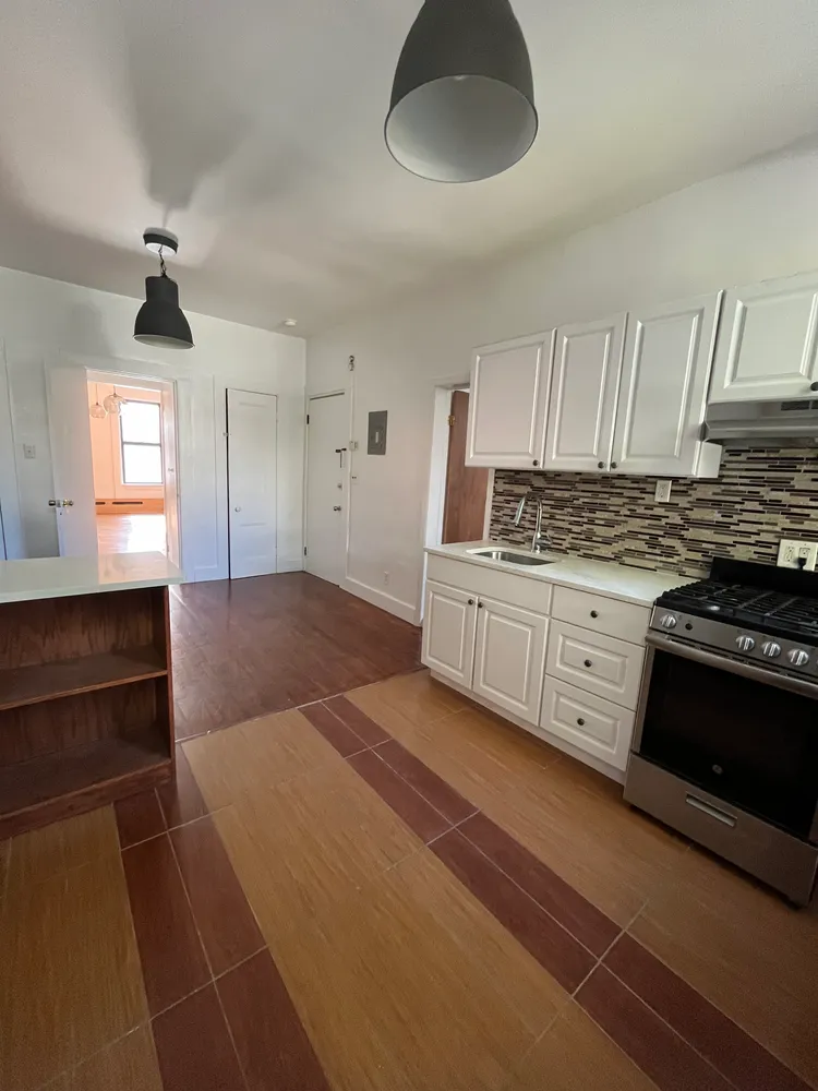 a kitchen with stainless steel appliances granite countertop a stove a sink and a refrigerator