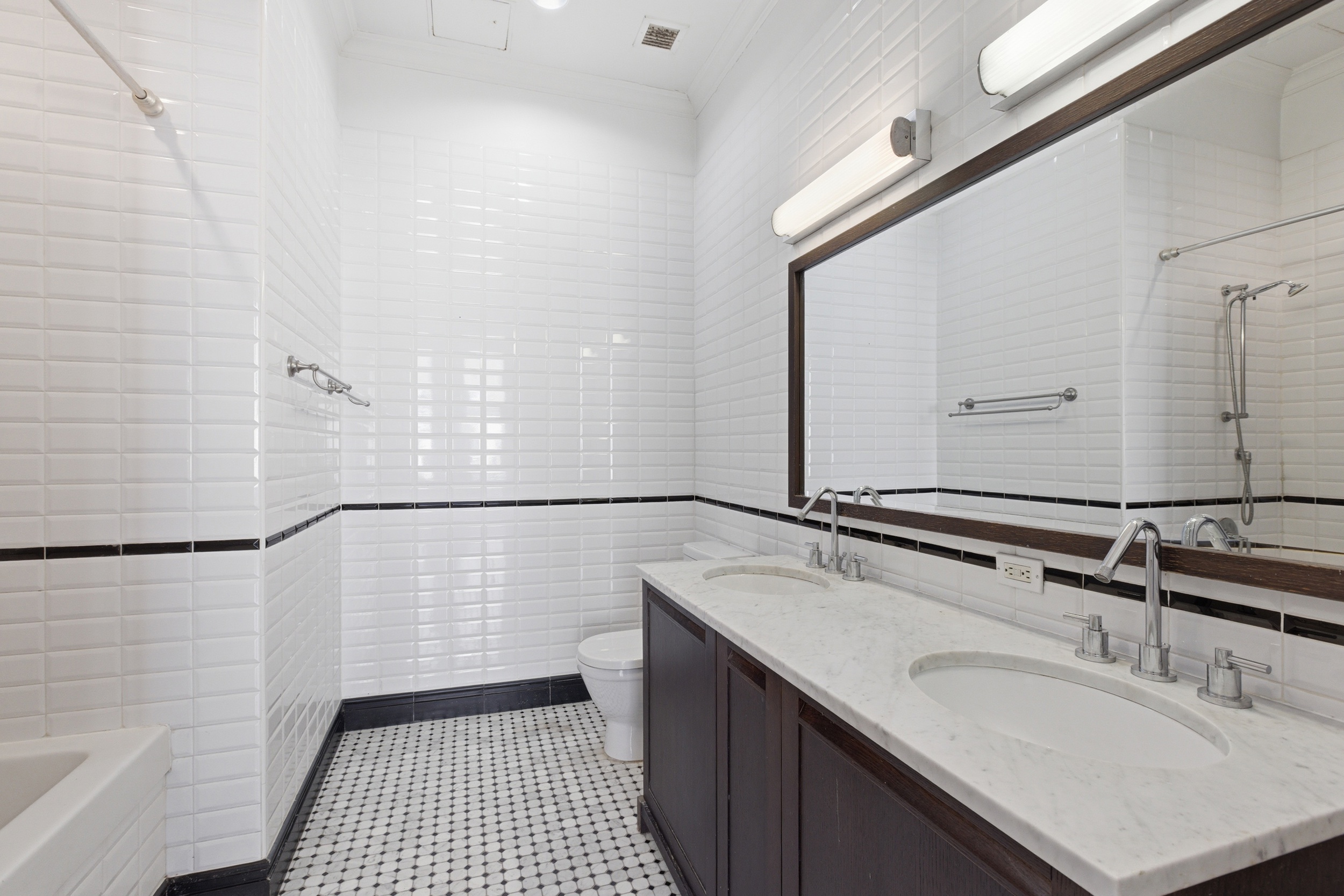 655 6th Avenue, Unit 3D Manhattan, NY 10010 - Photo 12 of 20 a bathroom with a sink a mirror and shower
