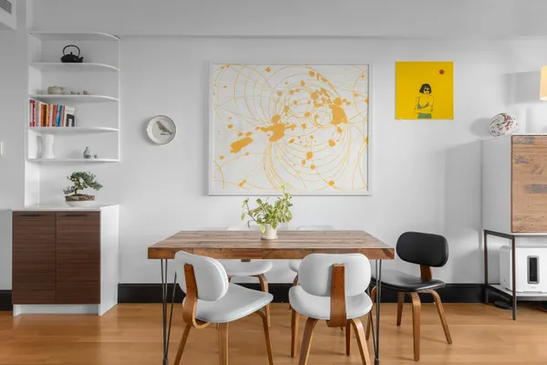 a dining room with furniture and wooden floor