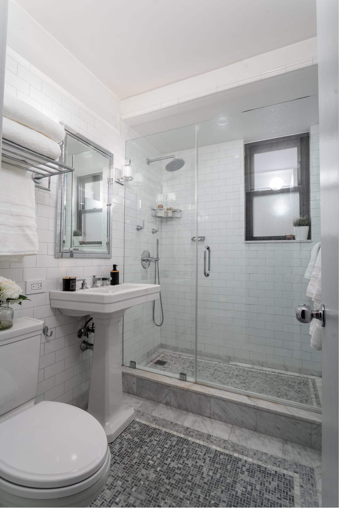 315 East 72nd Street, Unit 16A Manhattan, NY 10021 - Photo 8 of 12 a bathroom with a sink a toilet and shower