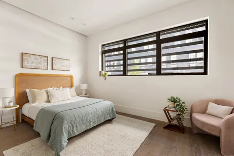 a bedroom with a bed and a couch