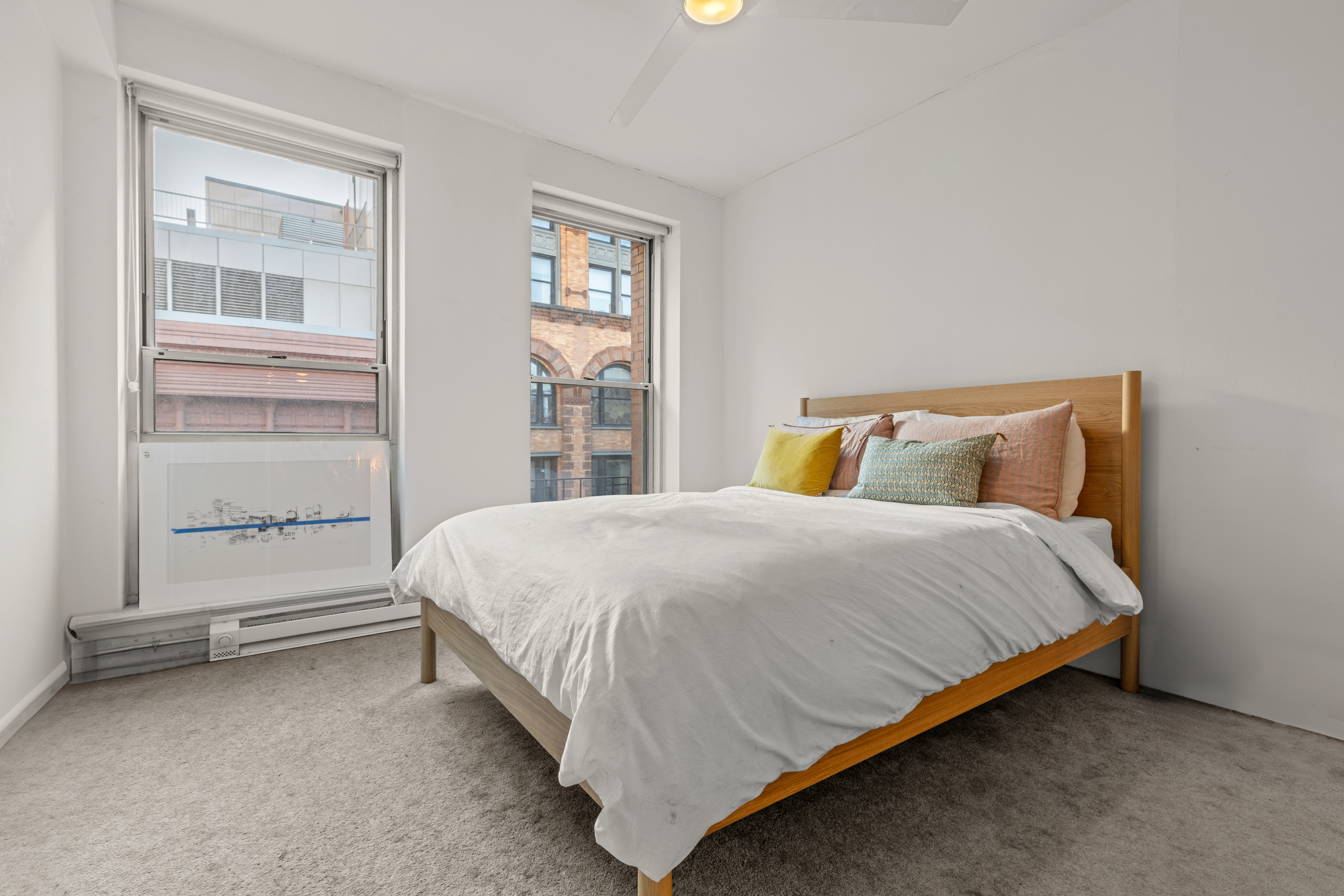 23 Waverly Place, Unit 6M Manhattan, NY 10003 - Photo 10 of 22 a large bed sitting in a bedroom next to a window