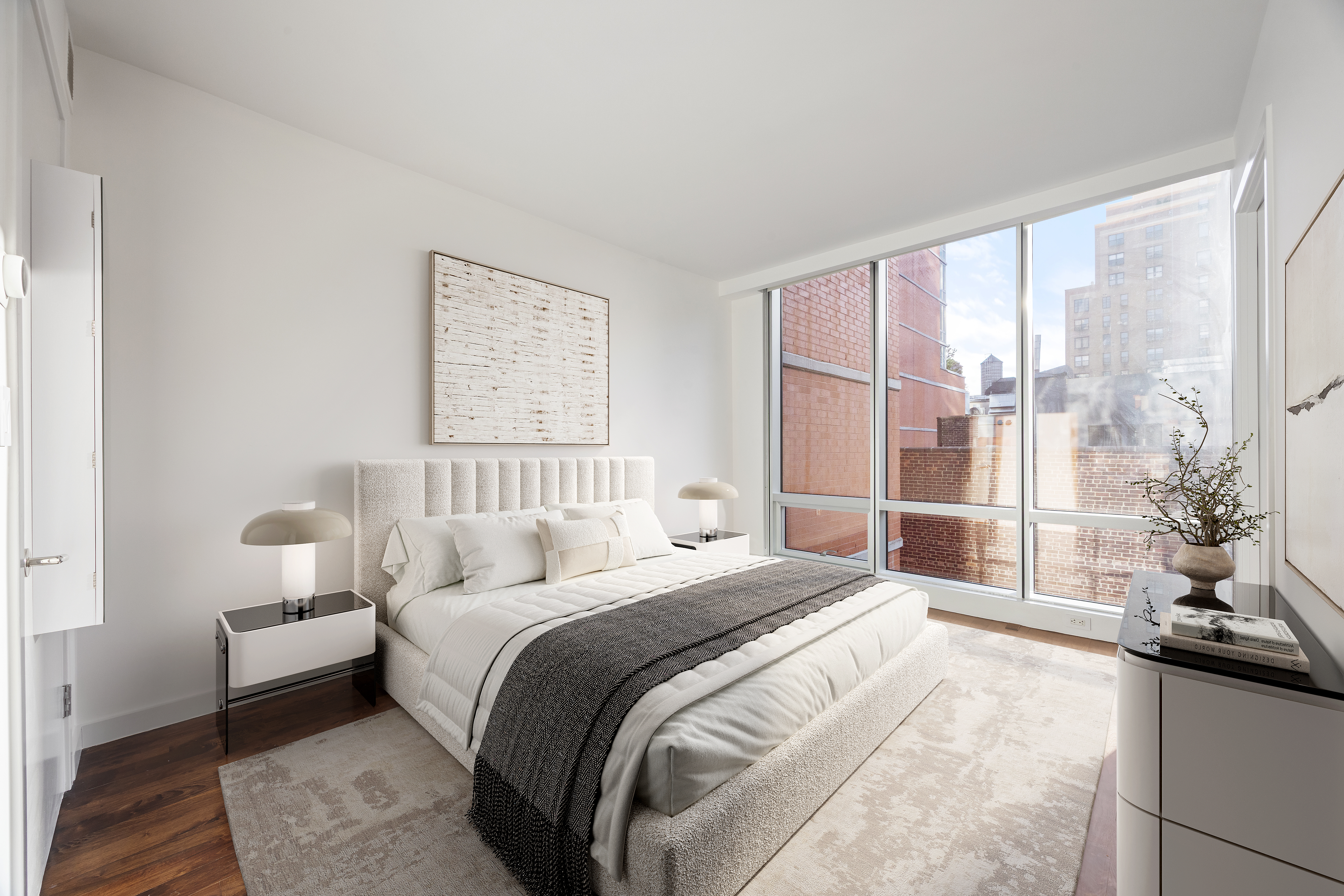 166 West 18th Street, Unit 7D Manhattan, NY 10011 - Photo 4 of 10 a bedroom with a large bed and a large window