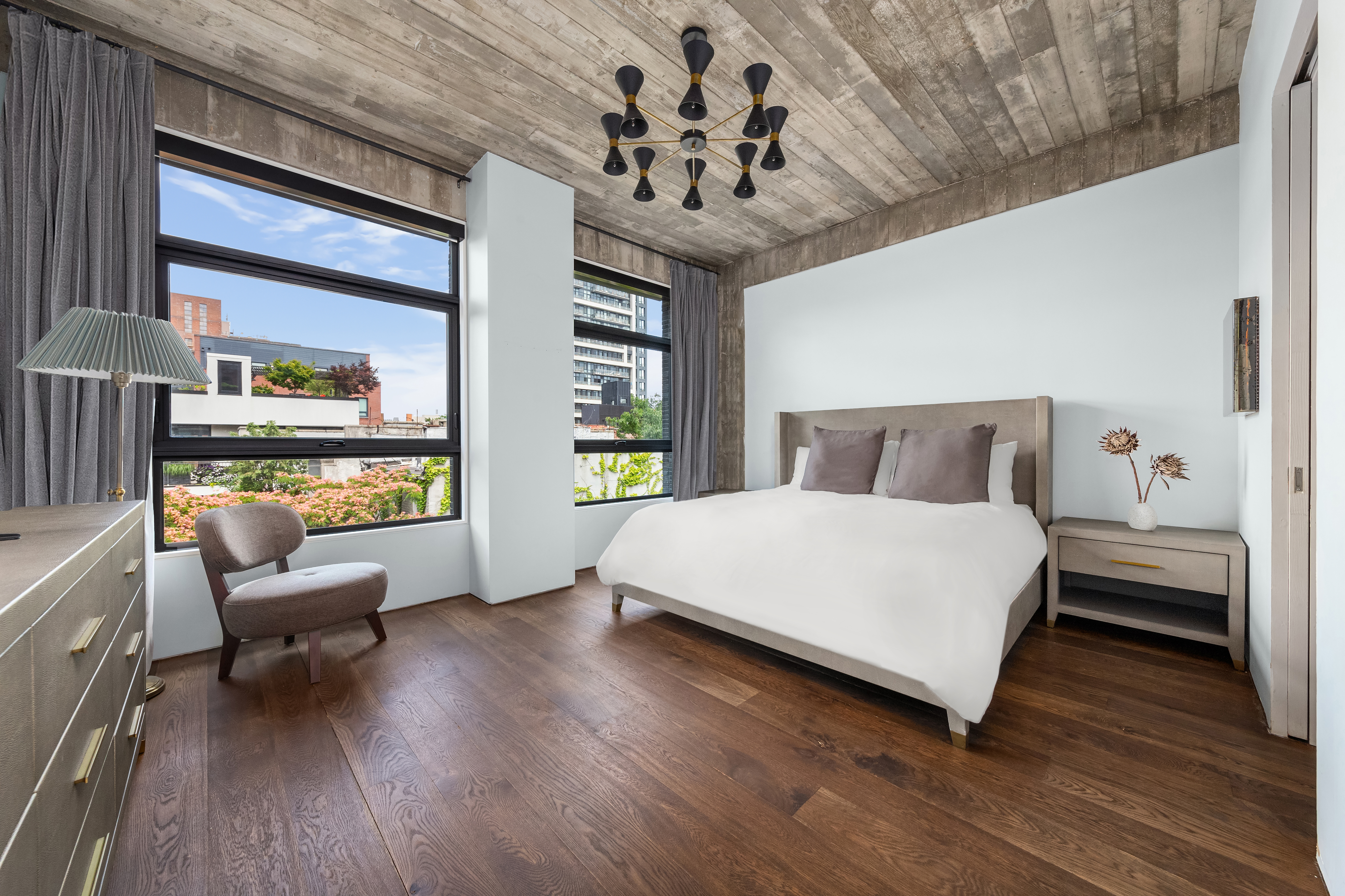 57 South 4th Street, Unit TH Brooklyn, NY 11249 - Photo 10 of 23 a bedroom with a bed and a chandelier