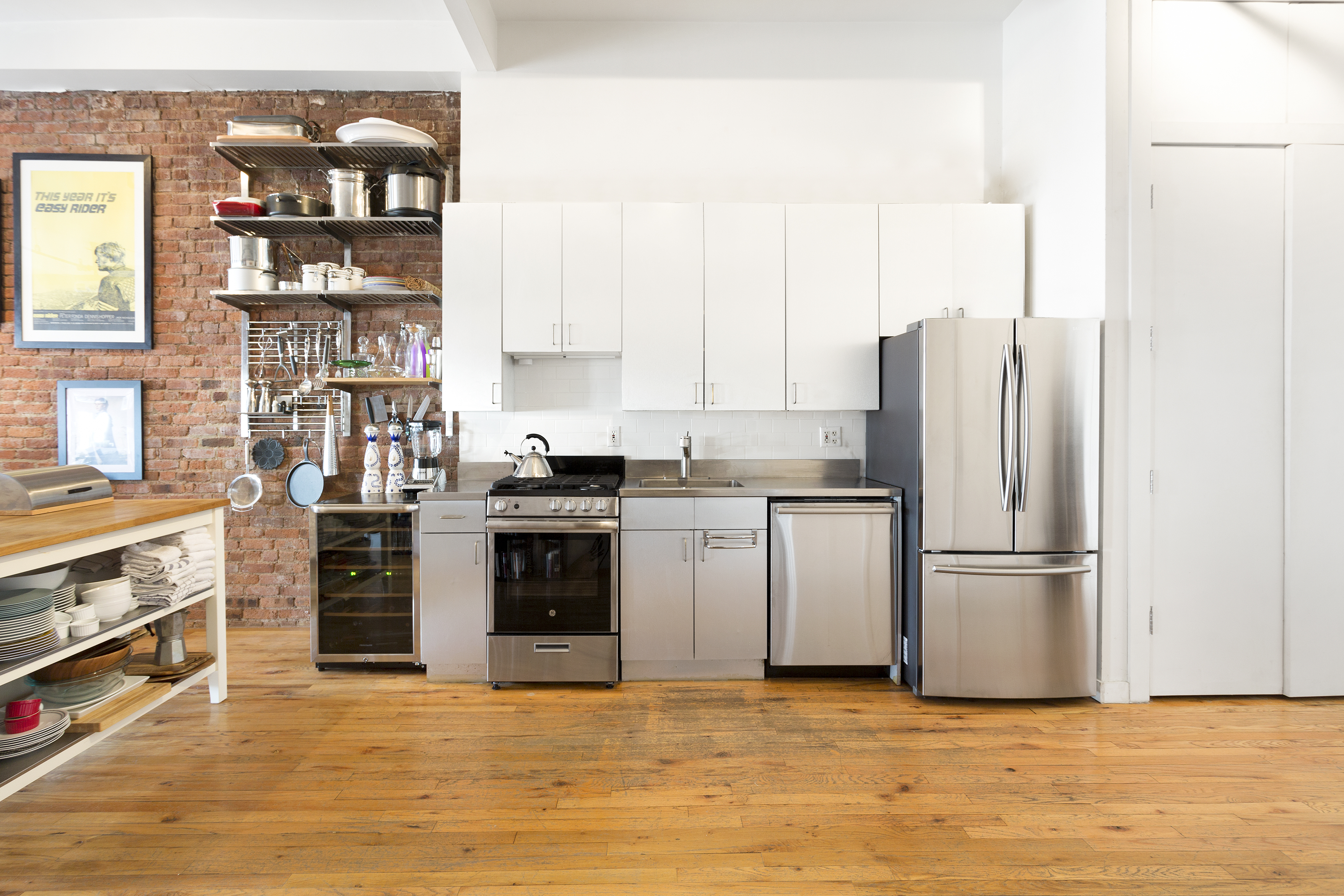 272 Water Street, Unit 5F Manhattan, NY 10038 - Photo 7 of 12 a kitchen with stainless steel appliances granite countertop a refrigerator and a stove top oven