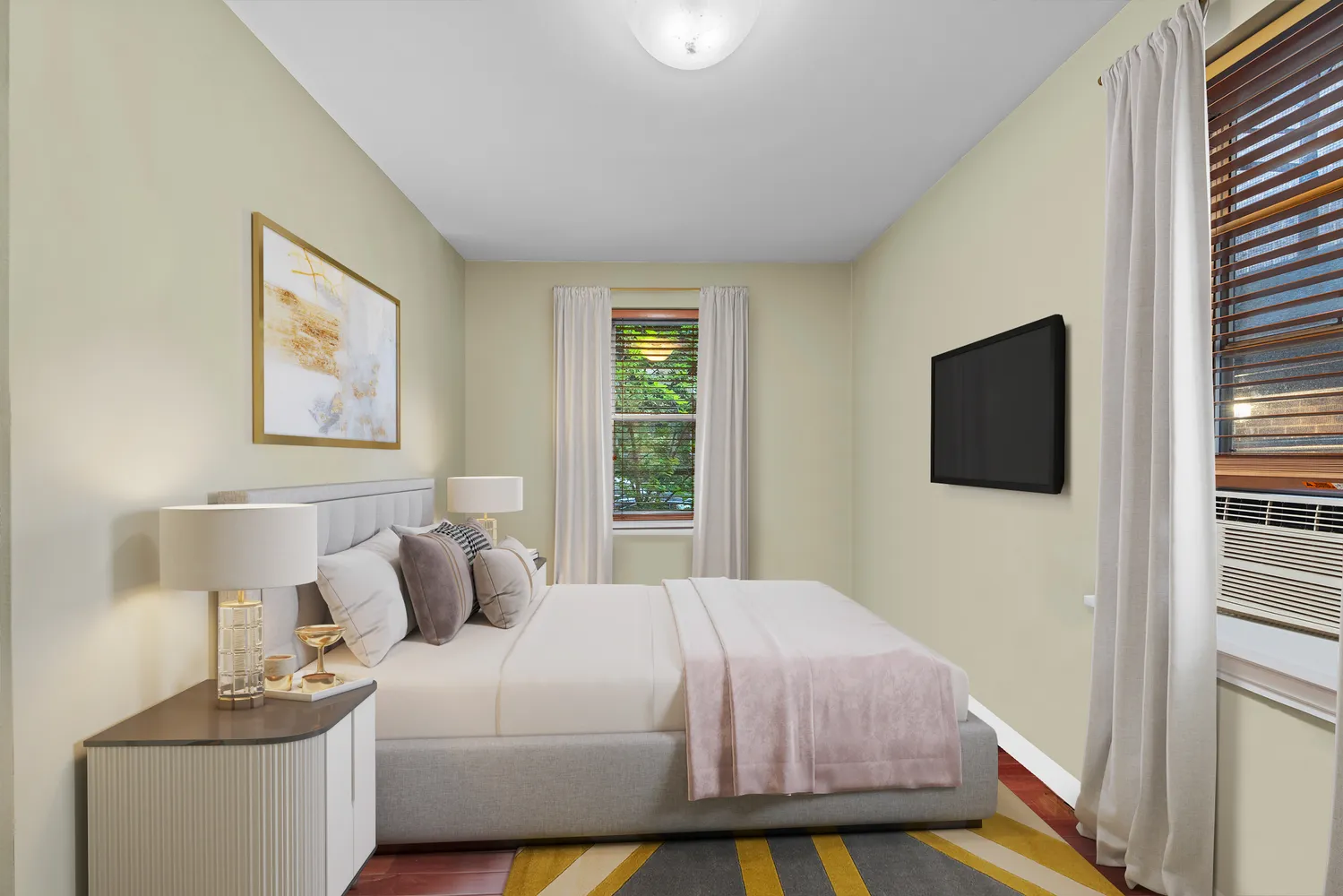 a bedroom with a bed and flat screen tv