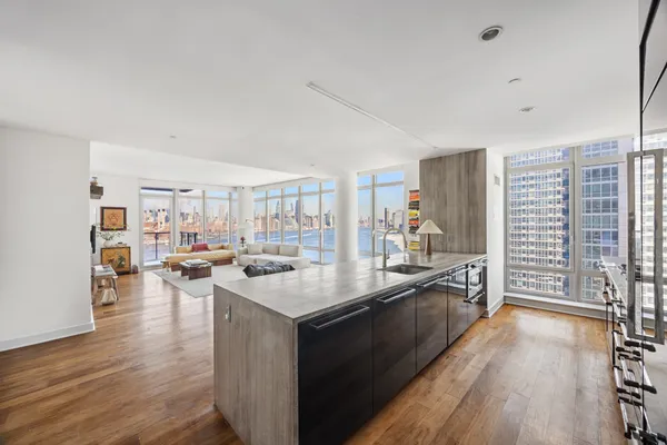 a kitchen with stainless steel appliances granite countertop a sink stove and wooden floor