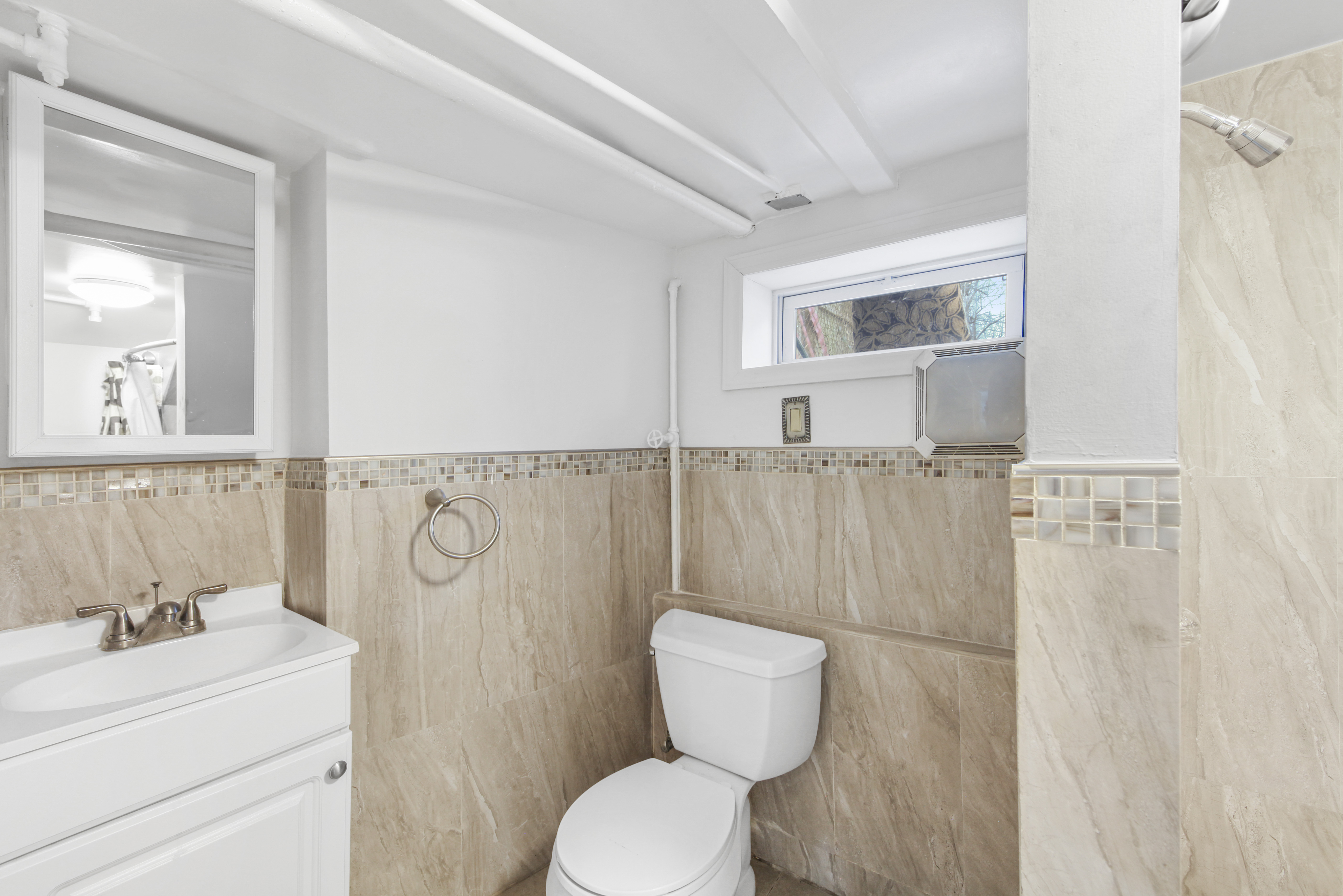 1530 East 51st Street Brooklyn, NY 11234 - Photo 9 of 14 a bathroom with a toilet a sink and a mirror