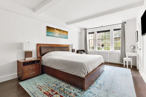 a bedroom with a large bed and a window