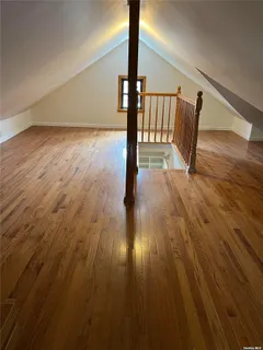 a view of a small space with wooden floor and closet