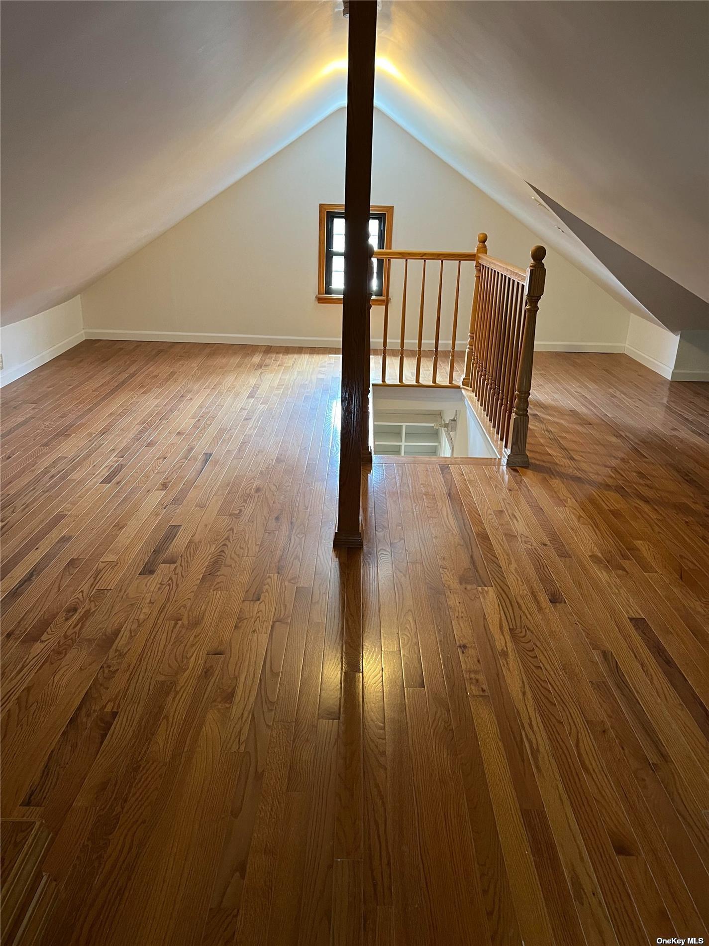 85-23 Edgerton Boulevard Queens, NY 11432 - Photo 21 of 36 a view of an empty room with wooden floor