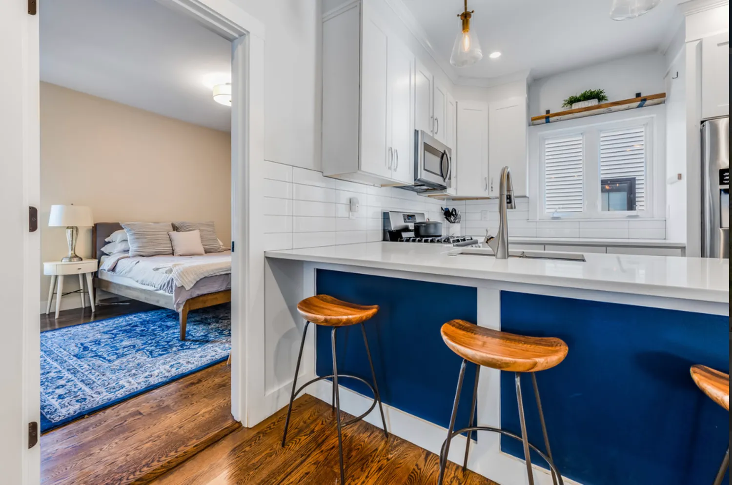 a kitchen with stainless steel appliances granite countertop a sink table and chairs