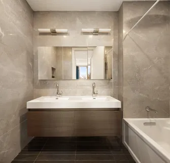 a bathroom with a double vanity sink and mirror