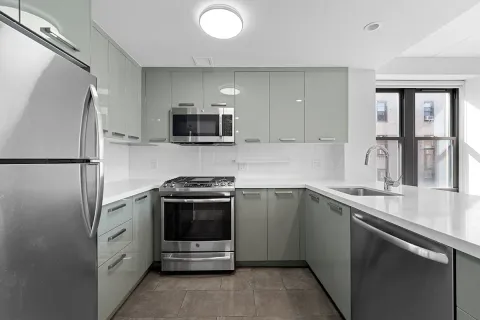 a kitchen with stainless steel appliances a sink stove and refrigerator