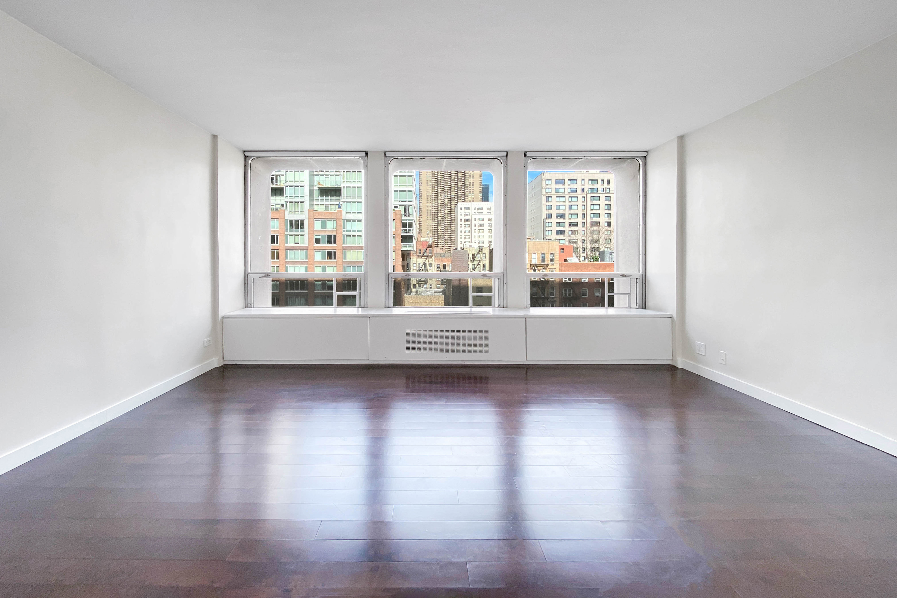 330 East 33rd Street, Unit 3F Manhattan, NY 10016 - Photo 1 of 15 a view of a big room with wooden floor and windows