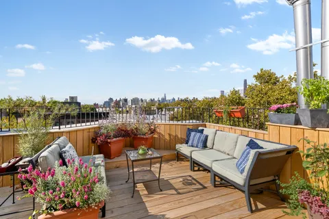 a terrace with outdoor seating and city view