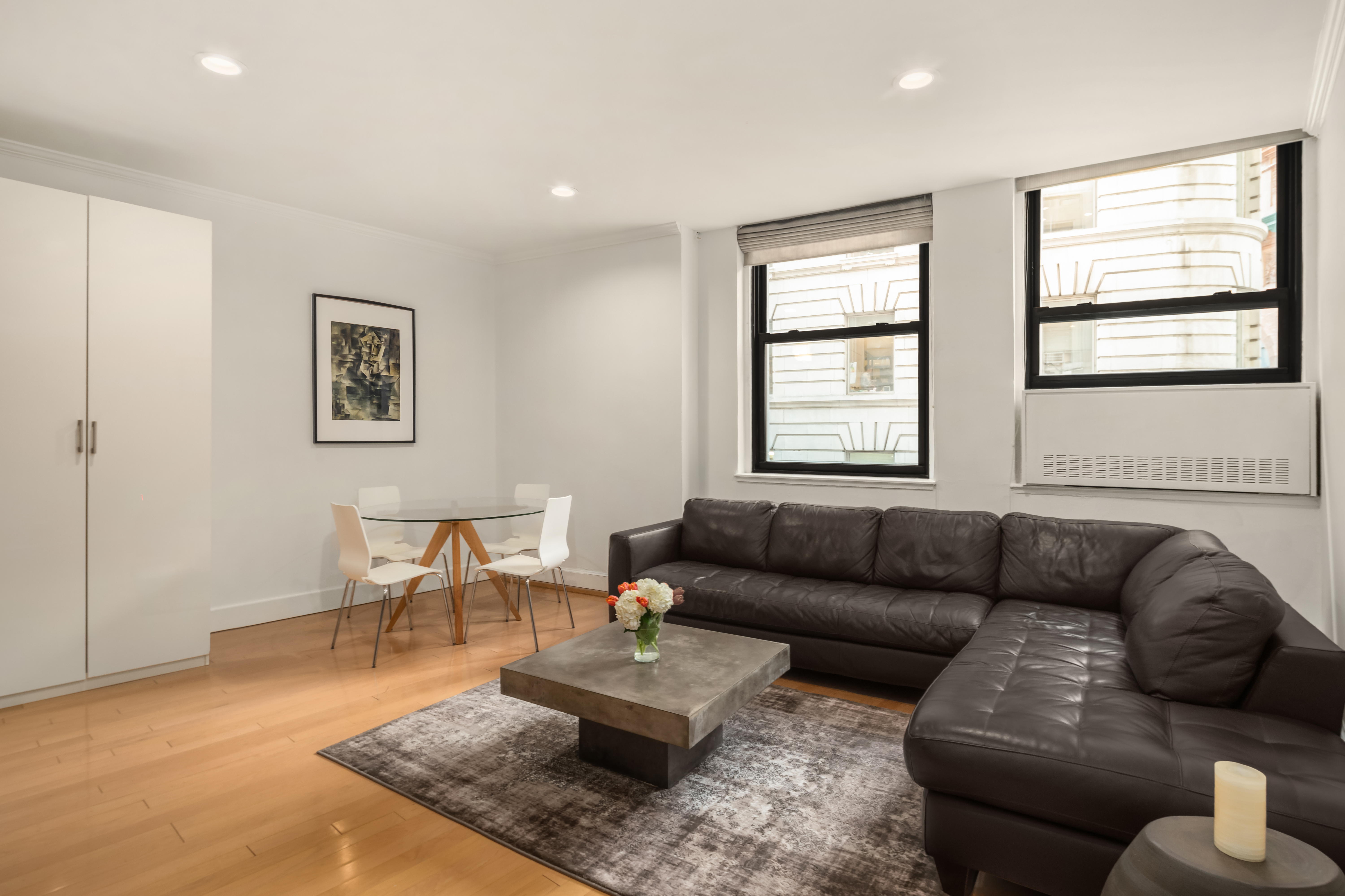 3 Hanover Square, Unit 4E Manhattan, NY 10004 - Photo 1 of 7 a living room with furniture and a window
