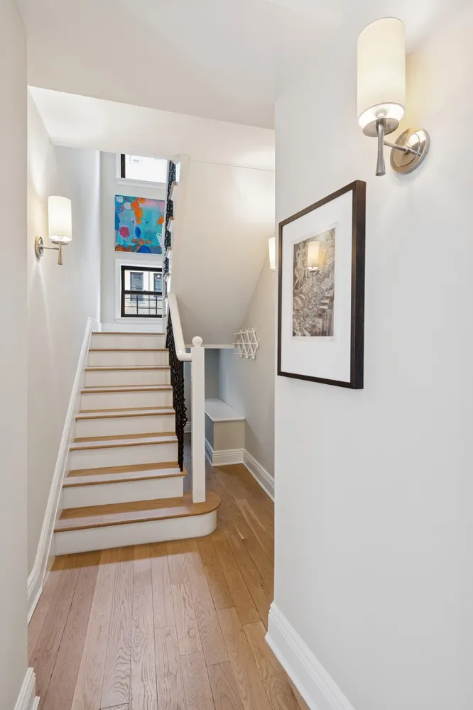 a view of a hallway with paintings on the wall
