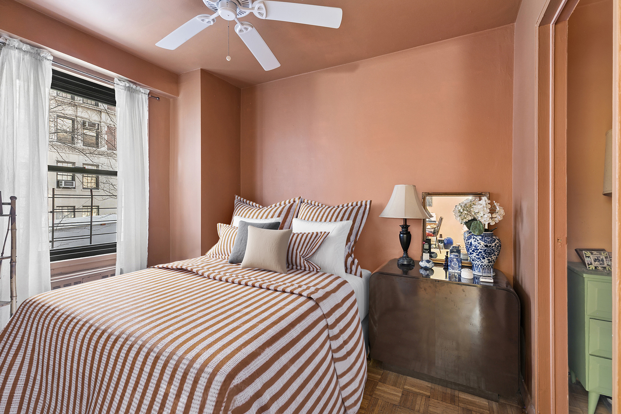 1199 Park Avenue, Unit 2J Manhattan, NY 10128 - Photo 4 of 8 a bedroom with a large bed and a chandelier