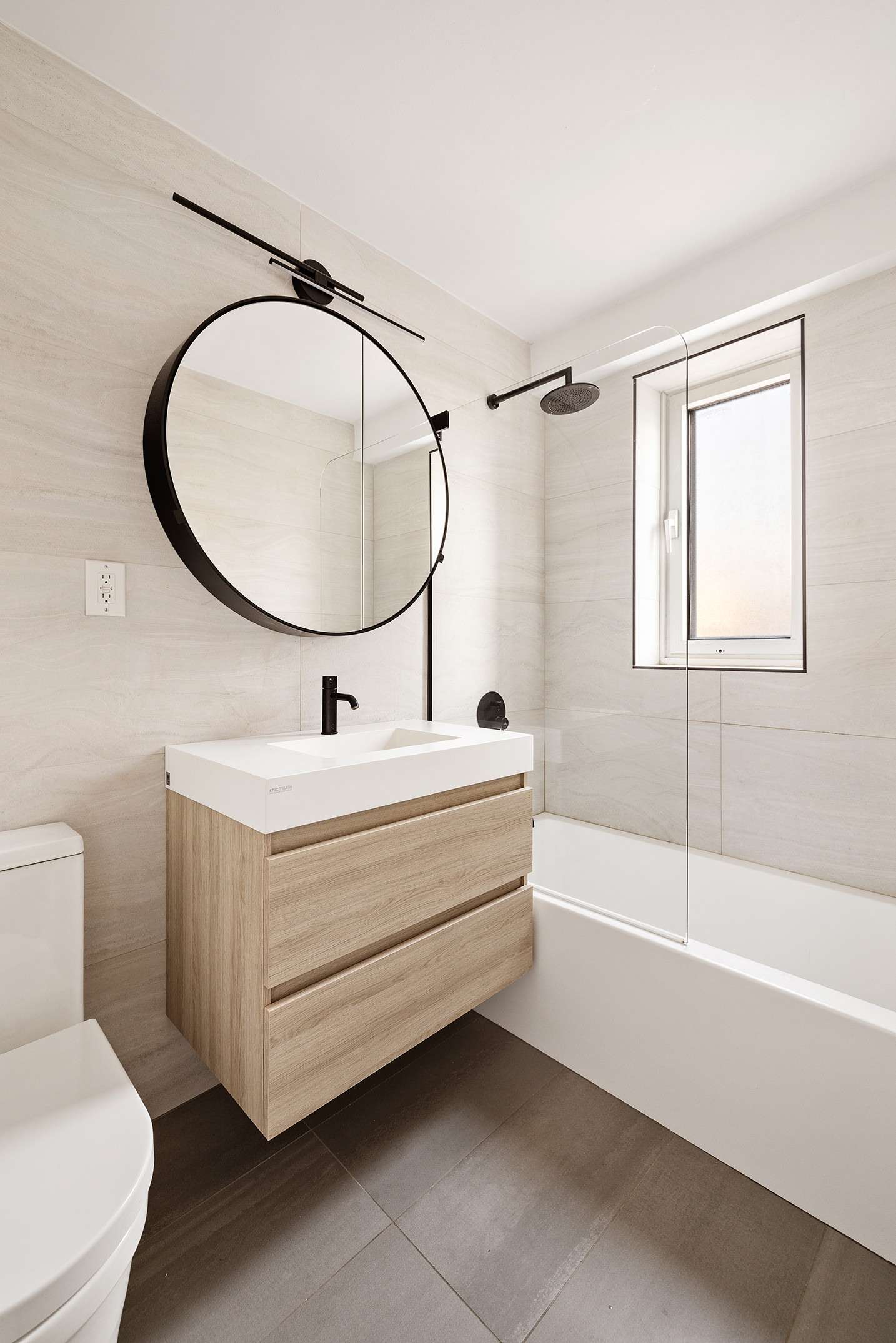 305 East 24th Street, Unit 11G Manhattan, NY 10010 - Photo 6 of 10 a bathroom with a sink a bathtub and a mirror