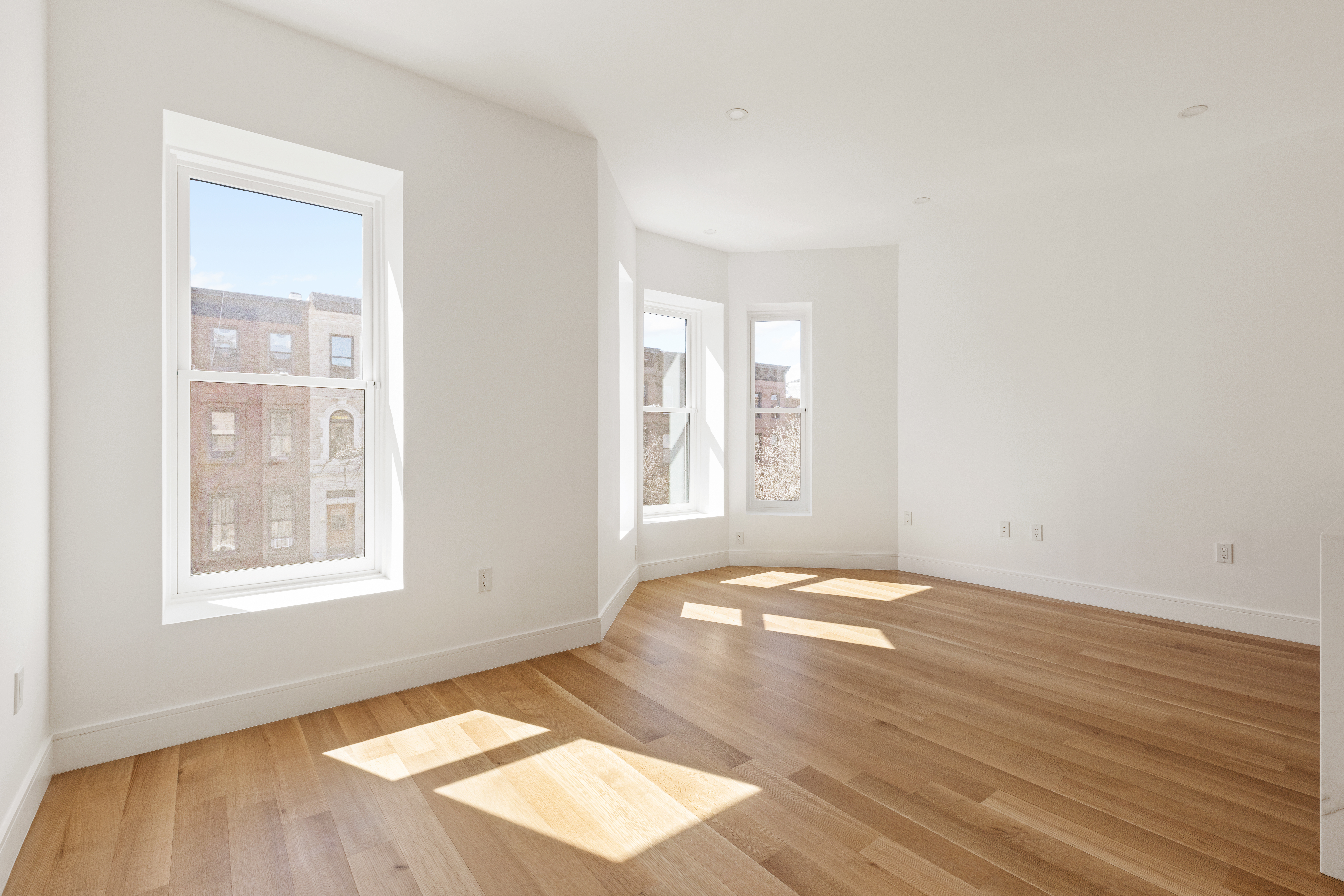 673 10th Street, Unit 2 Brooklyn, NY 11215 - Photo 2 of 13 an empty room with wooden floor and windows