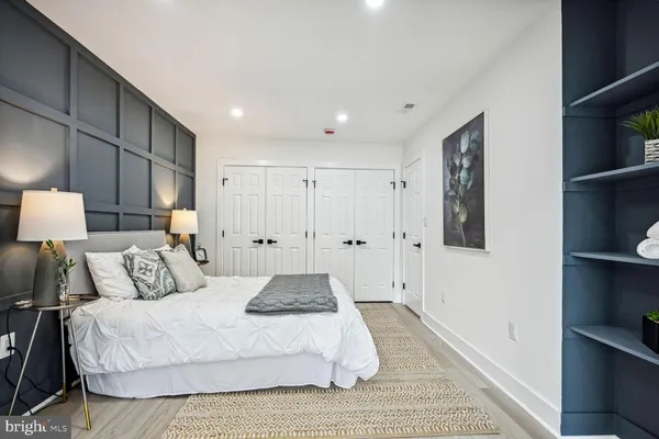 a bedroom with a bed and a book shelf