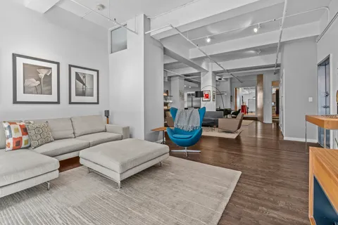 a living room with furniture and wooden floor