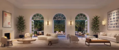 a living room with fireplace furniture and a large window