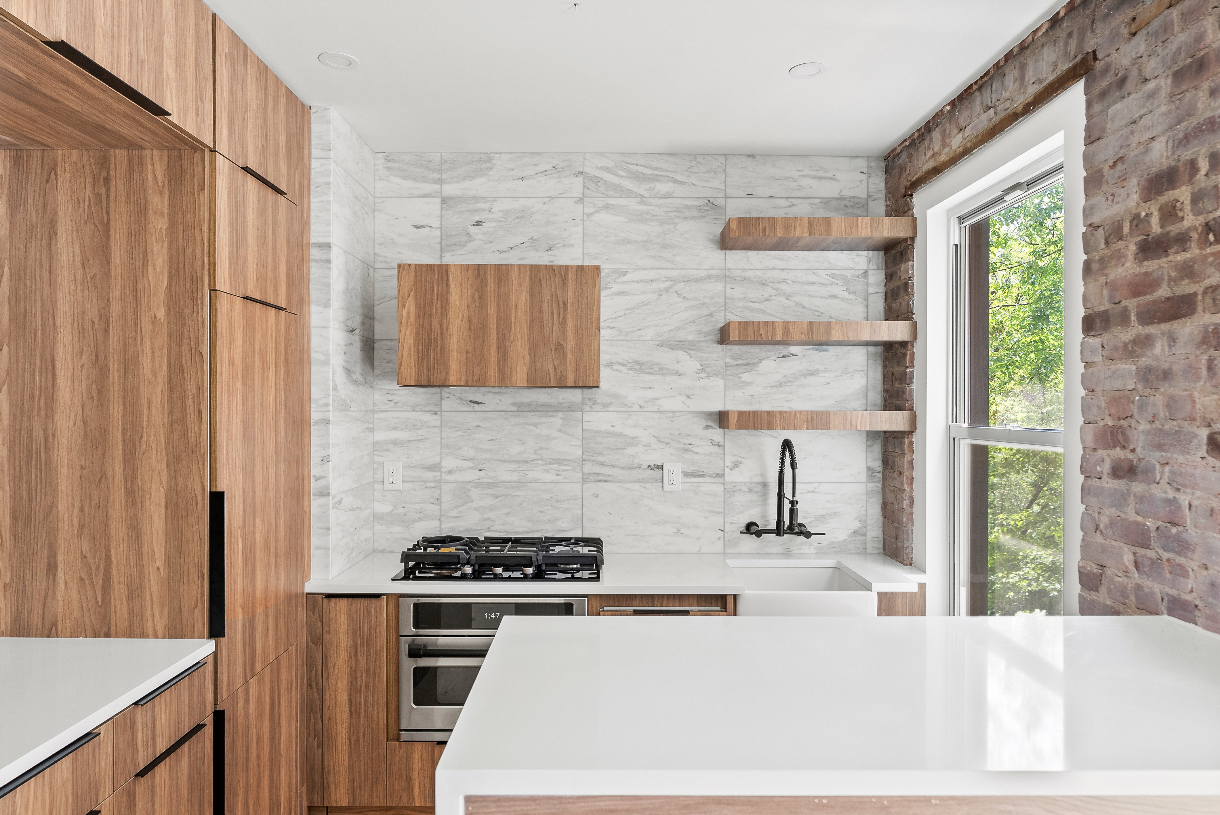 342 West 21st Street, Unit 3E Manhattan, NY 10011 - Photo 4 of 10 a kitchen with stainless steel appliances a stove a sink and a refrigerator