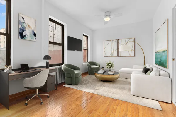 a living room with furniture and wooden floor