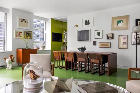 a living room with furniture and a garden