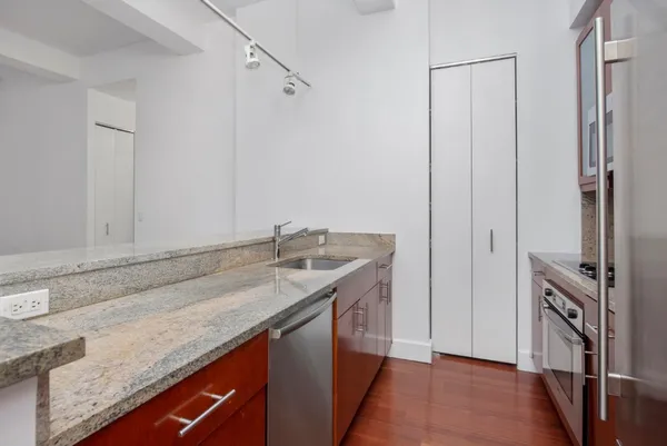 a bathroom with a granite countertop sink and a mirror