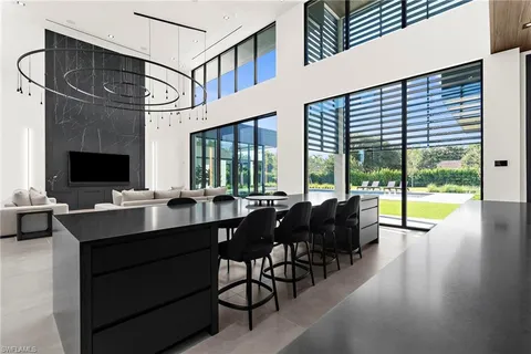 a view of a workspace with furniture and a large window