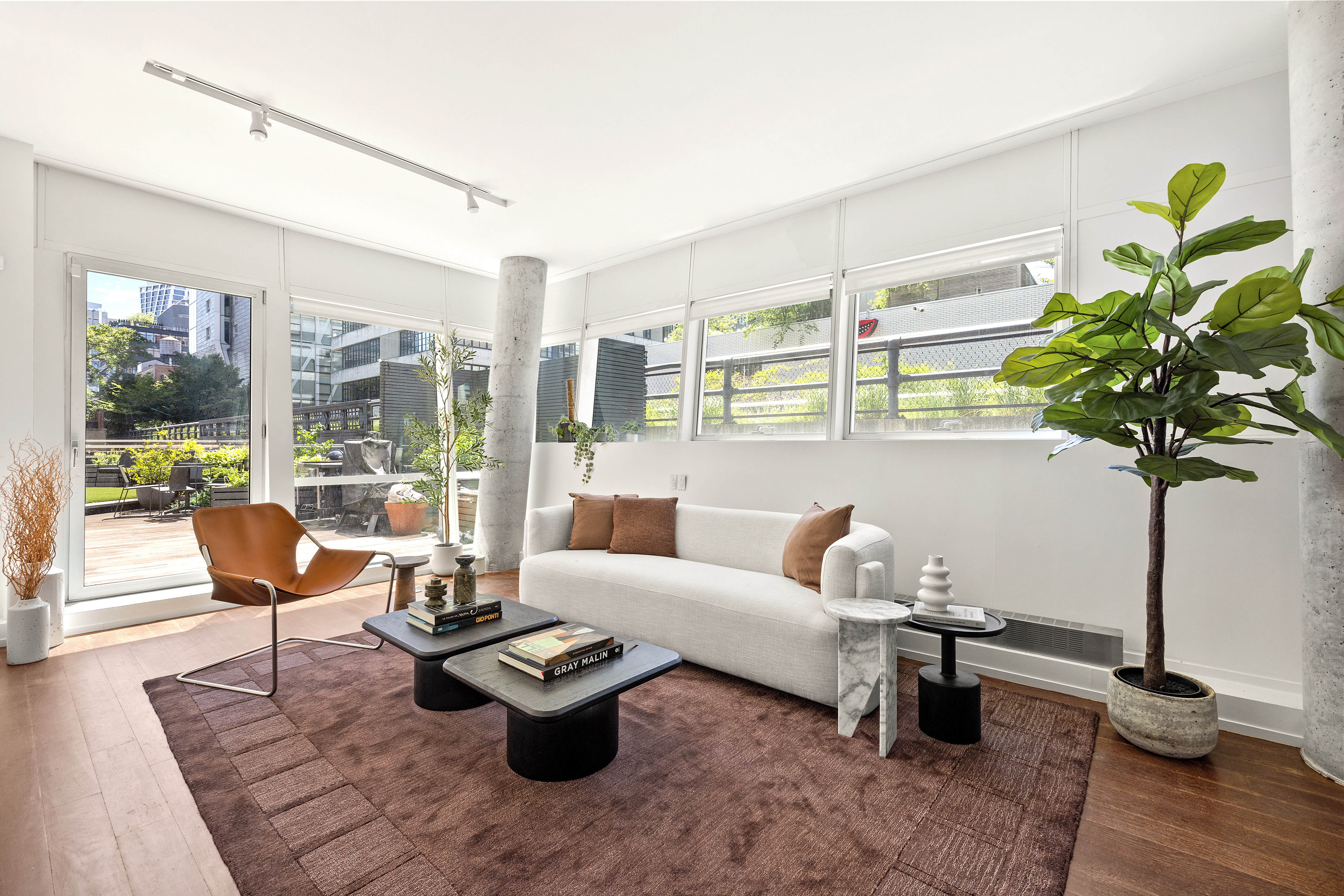 245 10th Avenue, Unit 2W Manhattan, NY 10001 - Photo 3 of 16 a living room with furniture and a potted plant