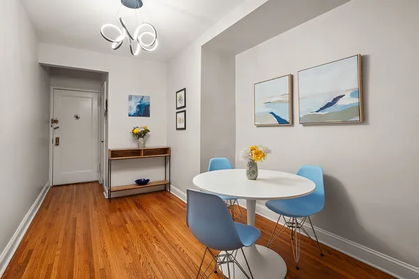 a view of a dining room with furniture wooden floor and a chandelier