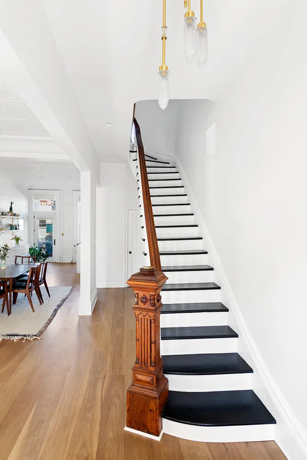 a view of entryway and hall with wooden floor