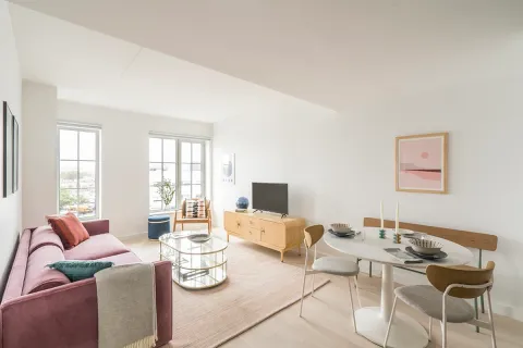 a living room with fireplace furniture and a wooden floor