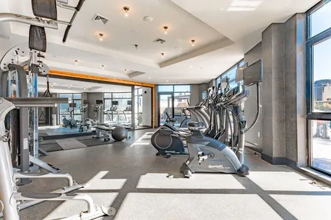 a room with gym equipment and a large window