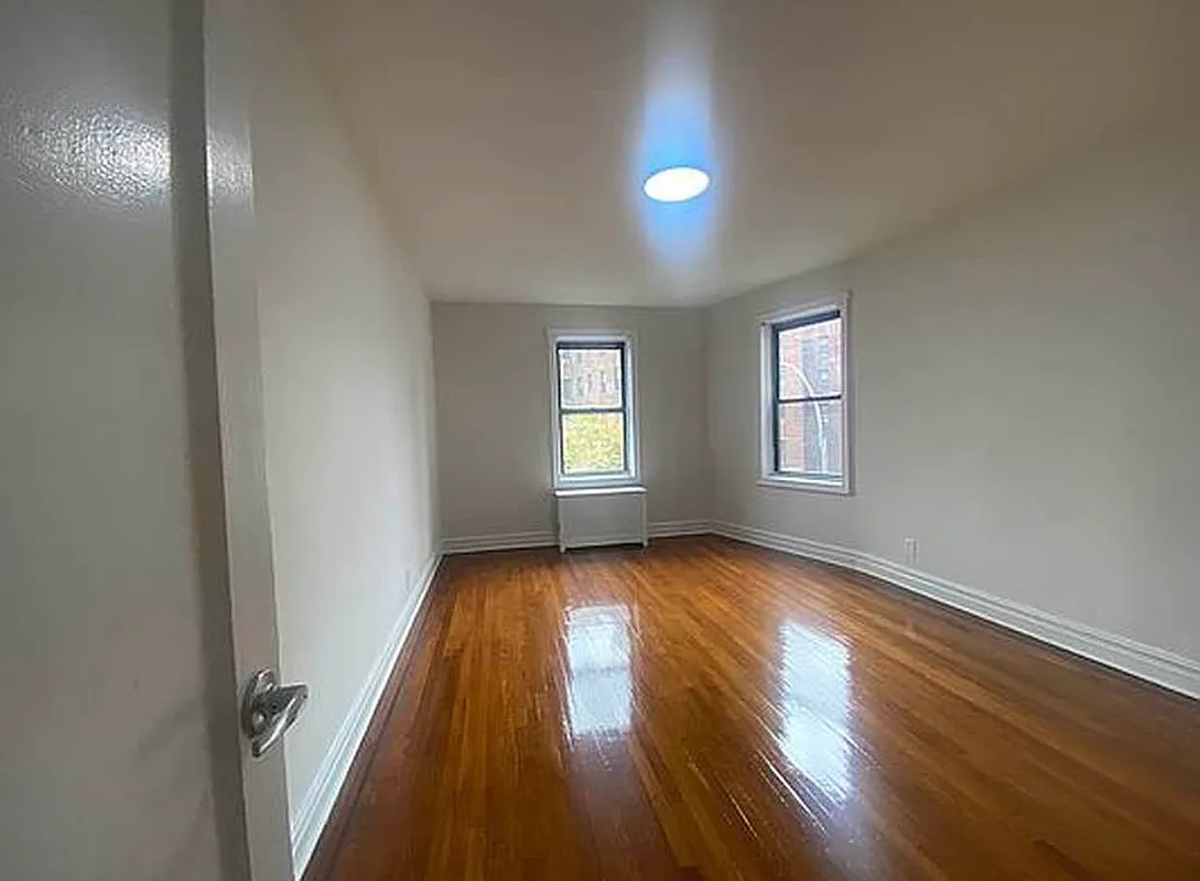 625 Caton Avenue, Unit 4E Brooklyn, NY 11218 - Photo 2 of 12 an empty room with wooden floor and windows