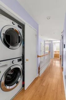 a view of a hallway with washer and dryer
