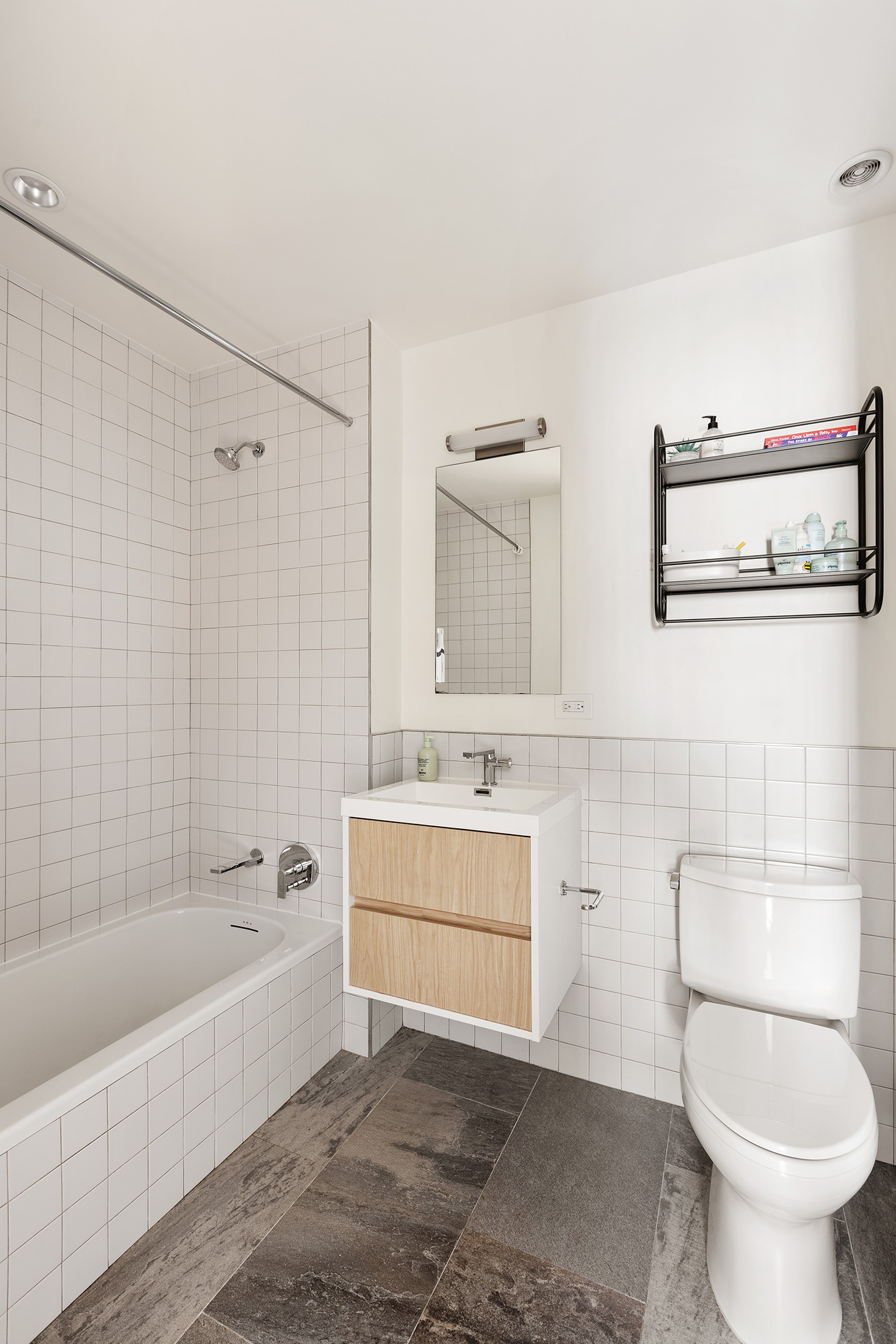 868 Lorimer Street, Unit 4C Brooklyn, NY 11222 - Photo 9 of 14 a bathroom with a sink a toilet and bathtub