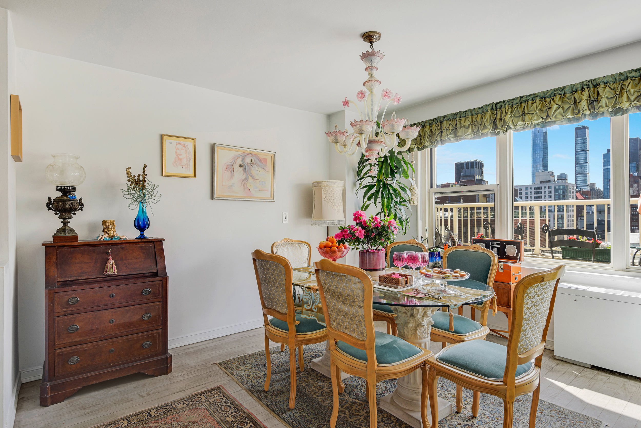 305 East 24th Street, Unit 18C Manhattan, NY 10010 - Photo 3 of 13 a dining room with furniture a chandelier and window