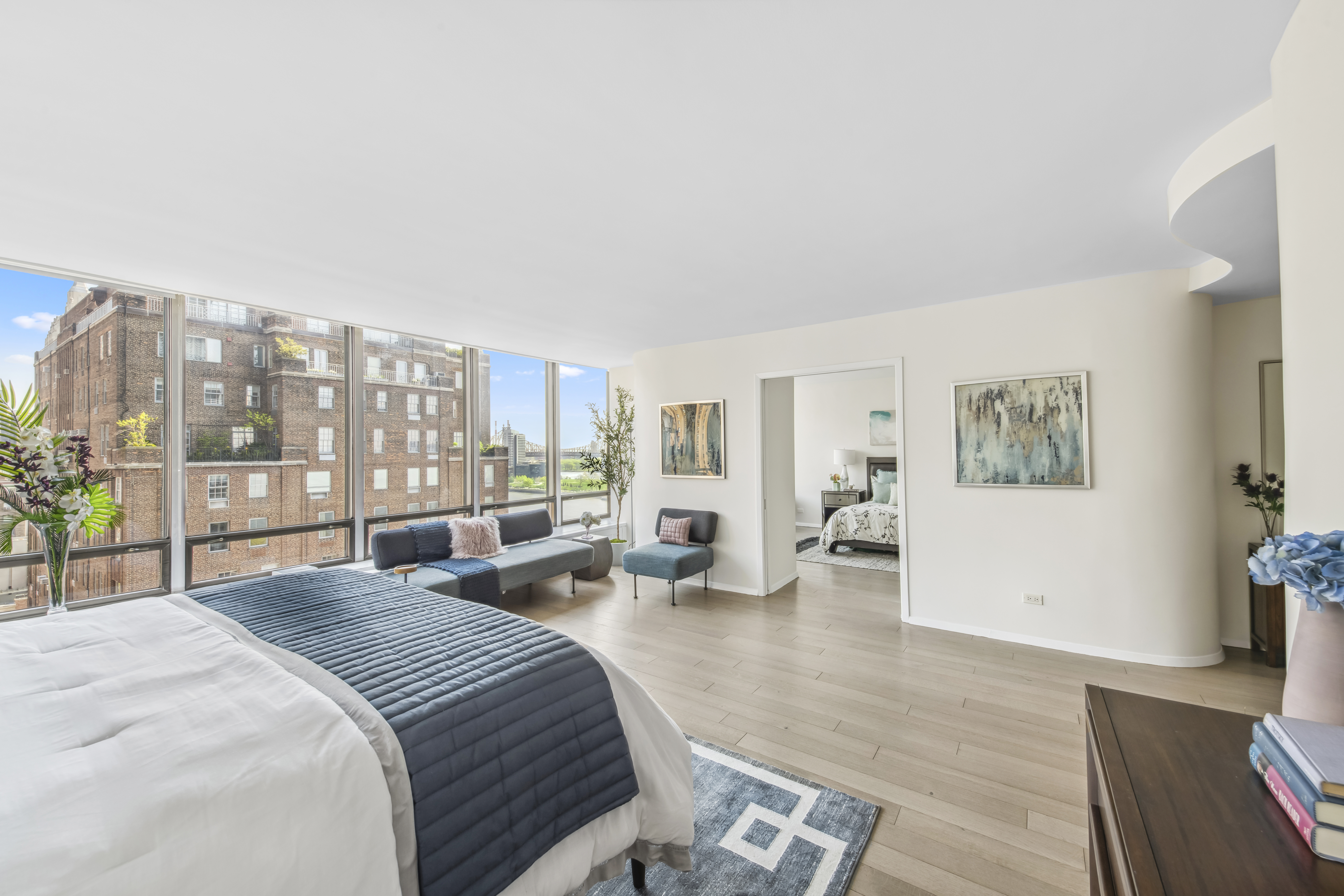 870 United Nations Plaza, Unit 15E Manhattan, NY 10017 - Photo 6 of 19 a bedroom with a large bed and a large window
