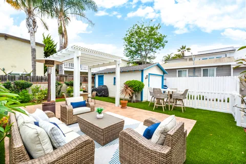 a porch with a bench next to a yard