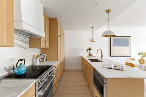 a kitchen that has a sink and a stove