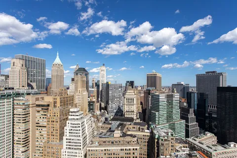 a view of a terrace with lawn chairs