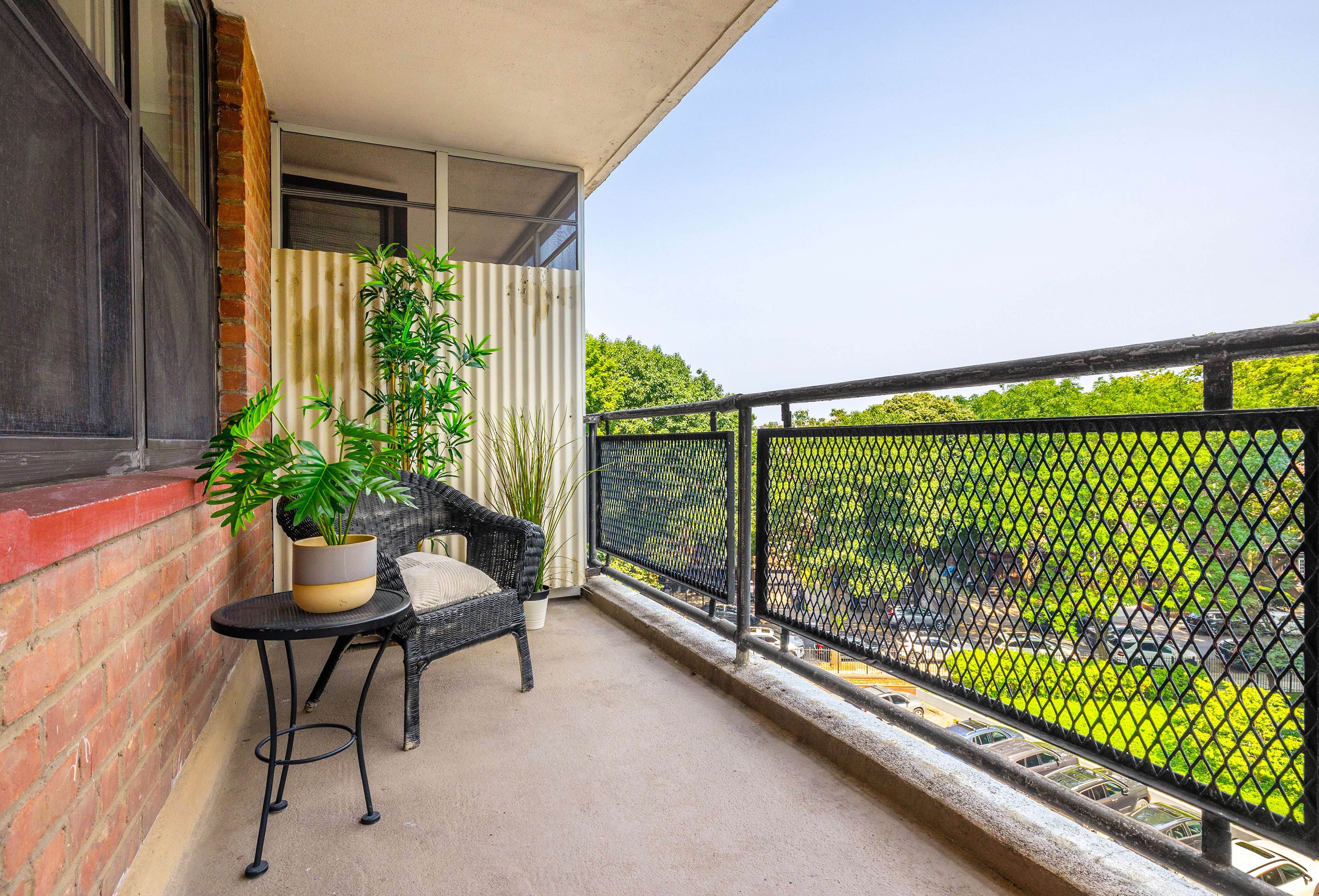 35-31 85th Street, Unit 6C Queens, NY 11372 - Photo 3 of 11 a balcony with table and chairs